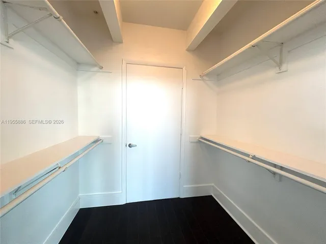 a bathroom with a granite countertop toilet and a sink