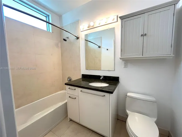 a living room with furniture and white walls