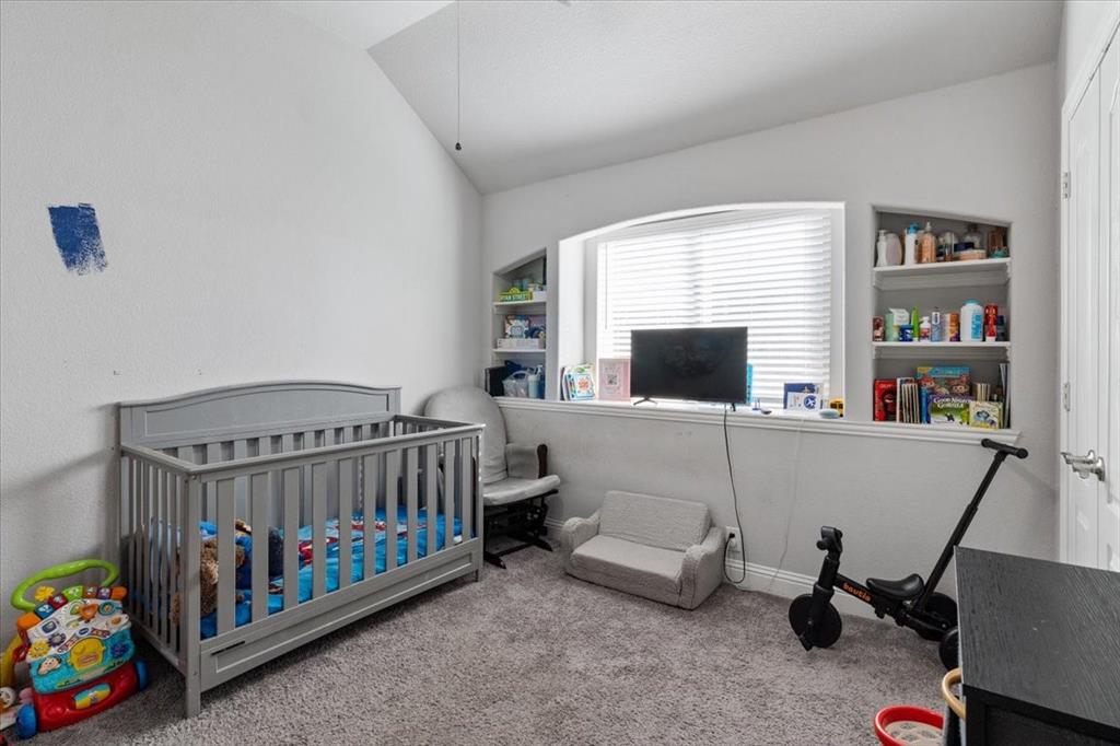 4209 Misty Ridge Street Mesquite, TX 75181 - Photo 13 of 40 a bedroom with furniture a window and a book shelf