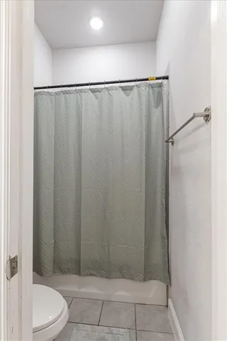 a bathroom with a shower and a toilet