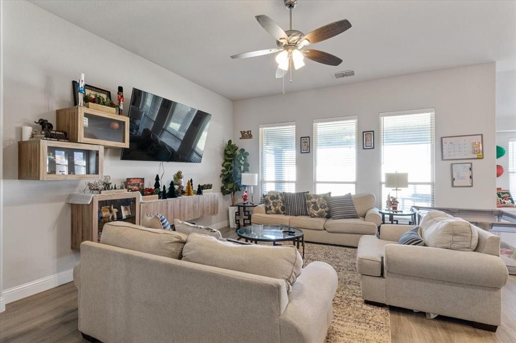 4209 Misty Ridge Street Mesquite, TX 75181 - Photo 19 of 40 a living room with furniture kitchen view and a flat screen tv
