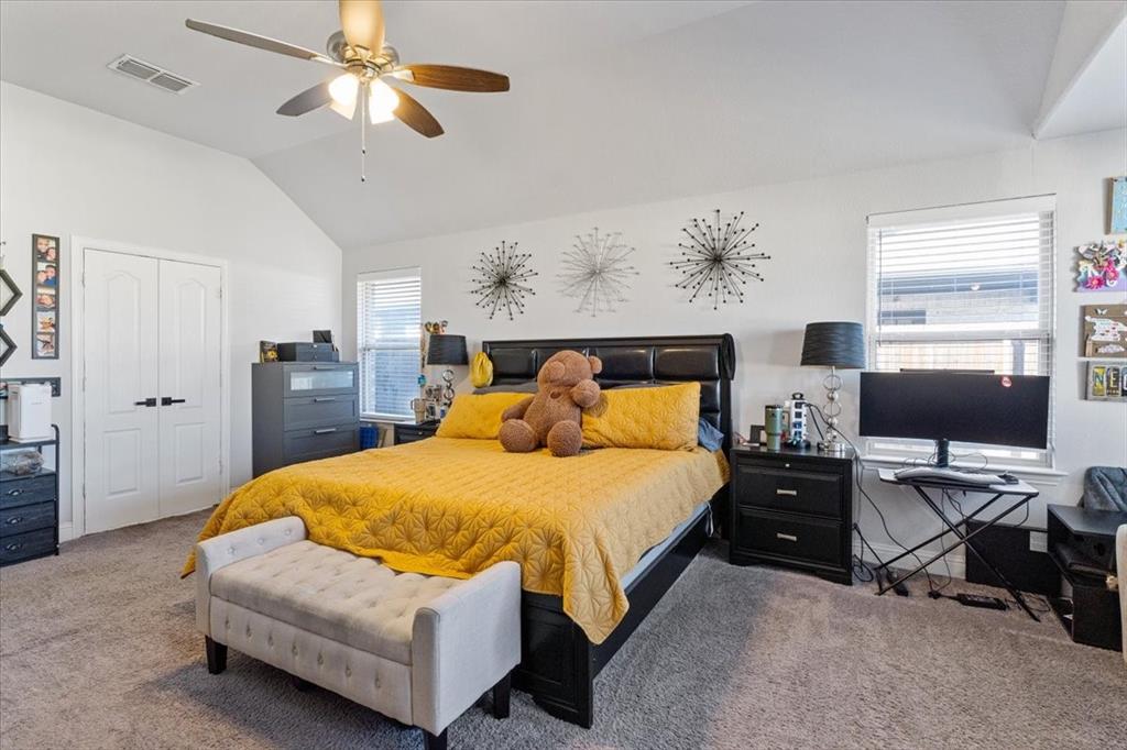 4209 Misty Ridge Street Mesquite, TX 75181 - Photo 26 of 40 a bedroom with a bed and a chandelier