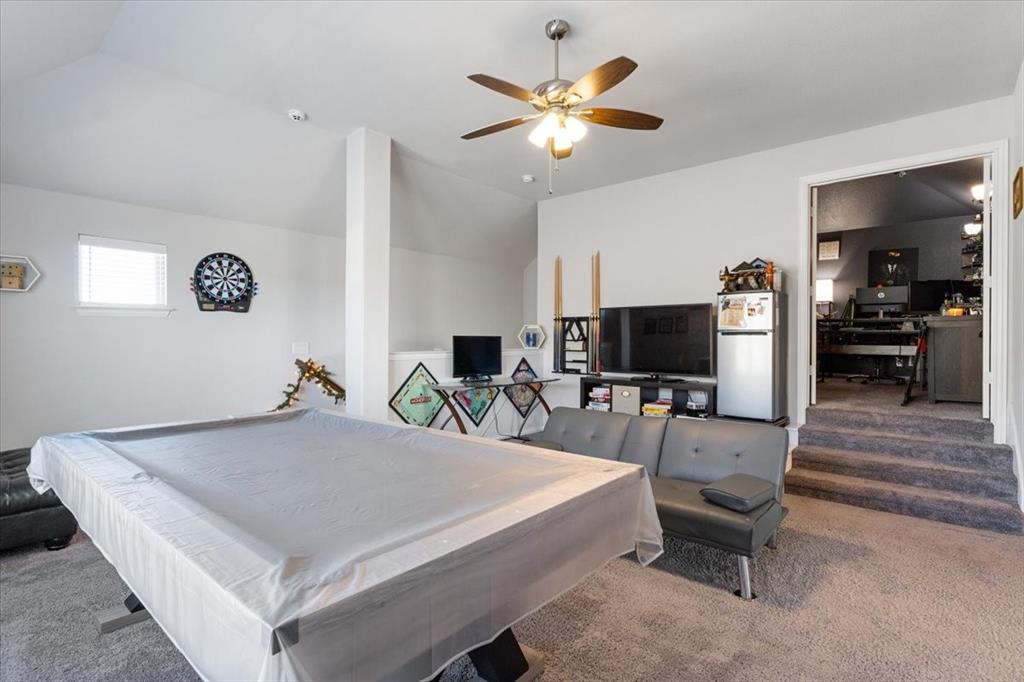 4209 Misty Ridge Street Mesquite, TX 75181 - Photo 31 of 40 a living room with furniture and a flat screen tv