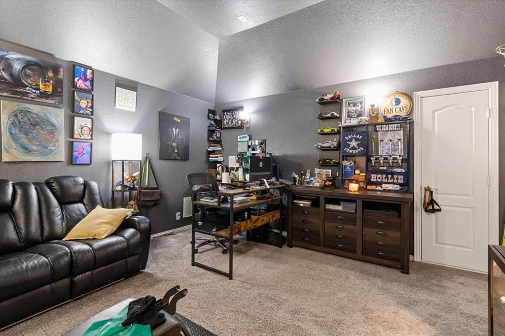 4209 Misty Ridge Street Mesquite, TX 75181 - Photo 32 of 40 a living room with couch and a bookshelf