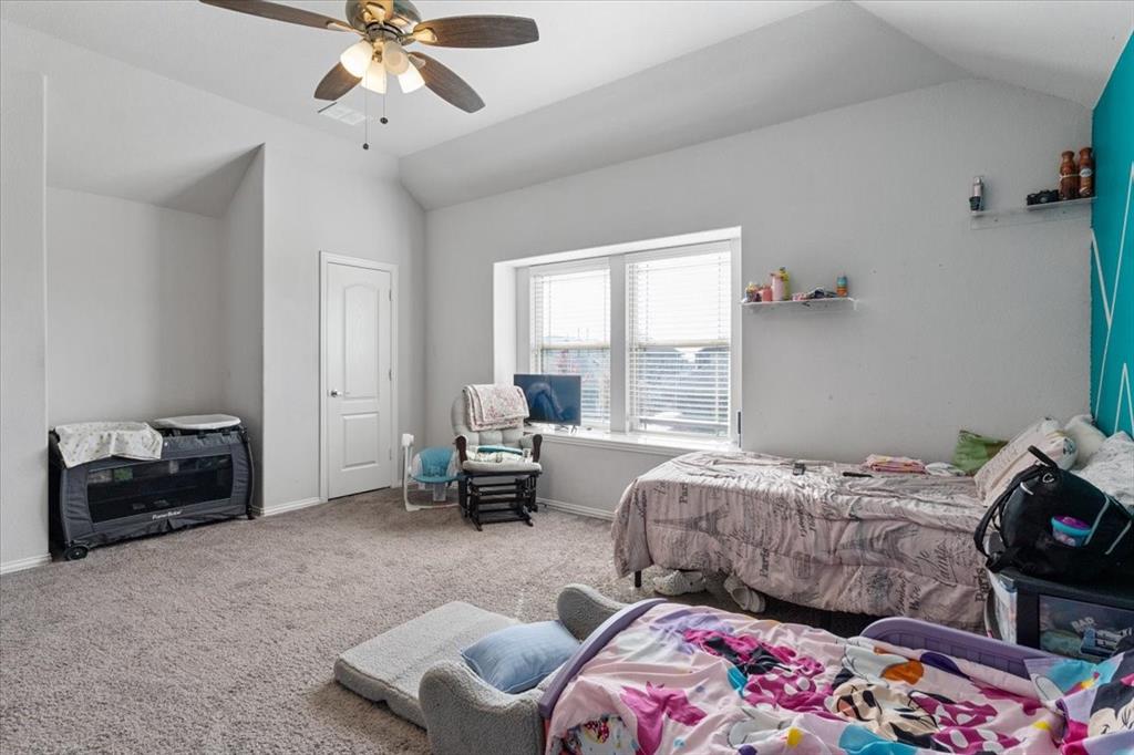 4209 Misty Ridge Street Mesquite, TX 75181 - Photo 35 of 40 a bedroom with a bed and a chandelier