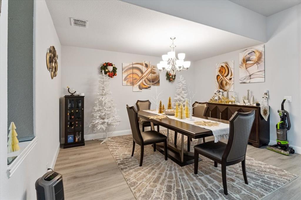 4209 Misty Ridge Street Mesquite, TX 75181 - Photo 10 of 40 a view of a dining room with furniture and wooden floor