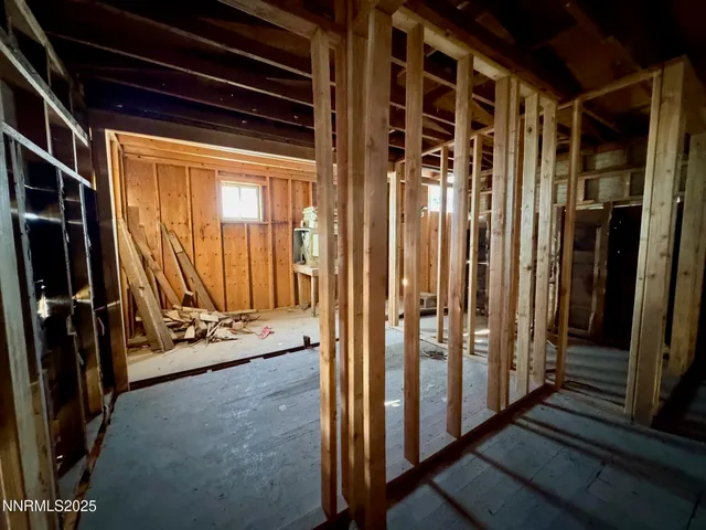a view of a hallway with wooden walls