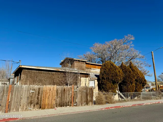 a backyard of a house with barbeque oven and outdoor seating