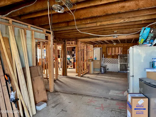 a view of a room with wooden floor and windows