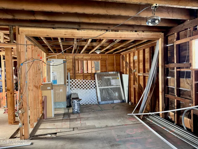 a living room with furniture a flat screen tv and a window