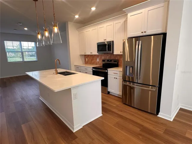 a kitchen with wooden cabinets and stainless steel appliances