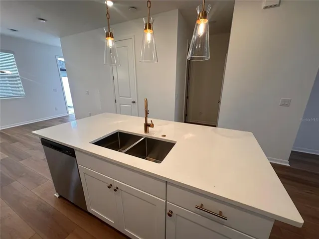 a kitchen with a sink and a refrigerator