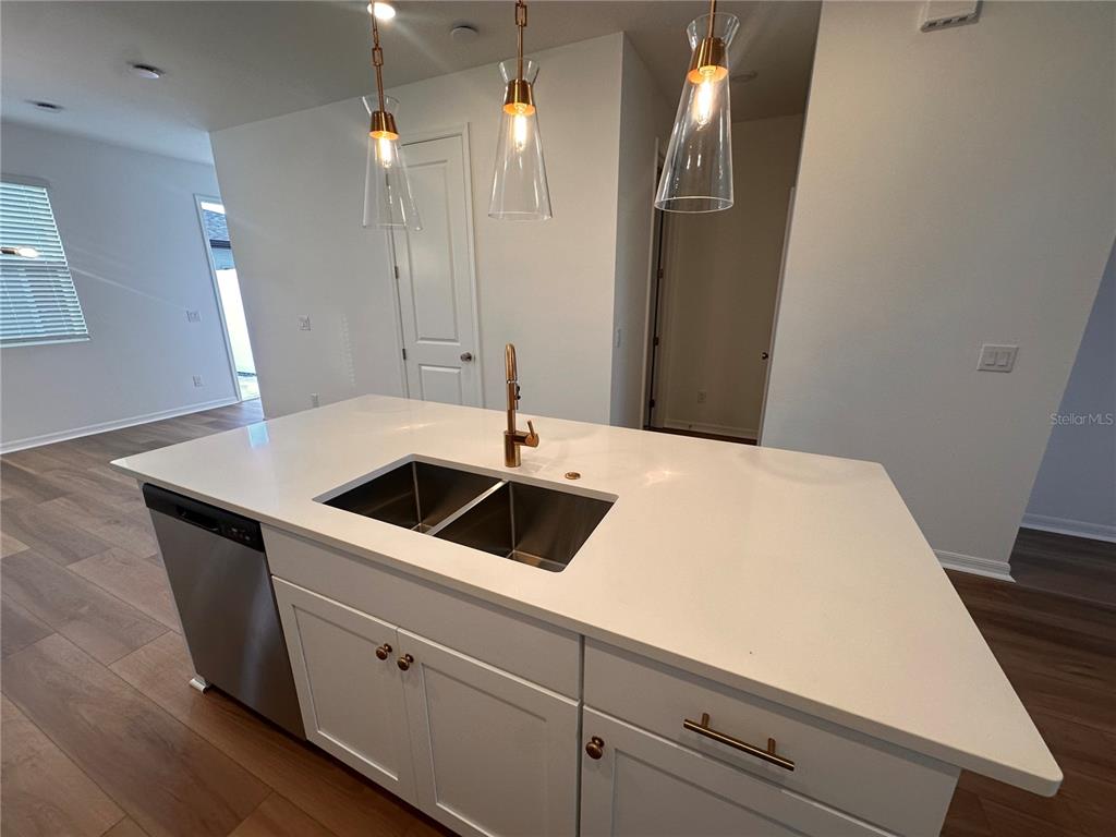 17592 Northlake Grv Drive Winter Garden, FL 34787 - Photo 4 of 14 a kitchen with a sink and a refrigerator