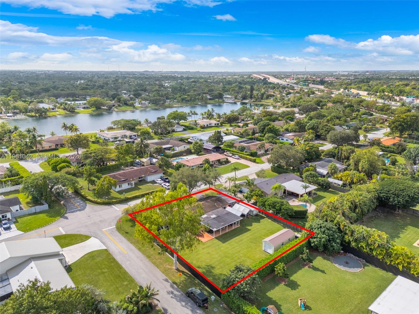 an aerial view of residential houses with outdoor space and river