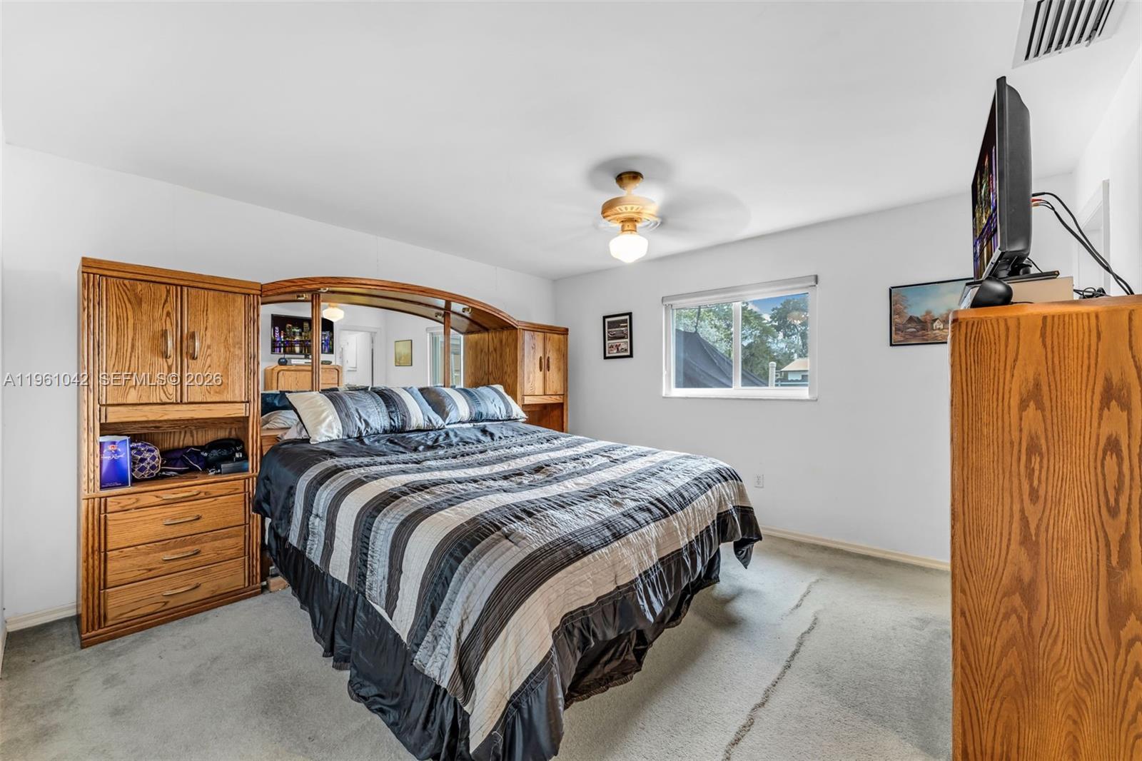 10901 Southwest 116th Street Miami, FL 33176 - Photo 14 of 26 a bedroom with a bed and a window