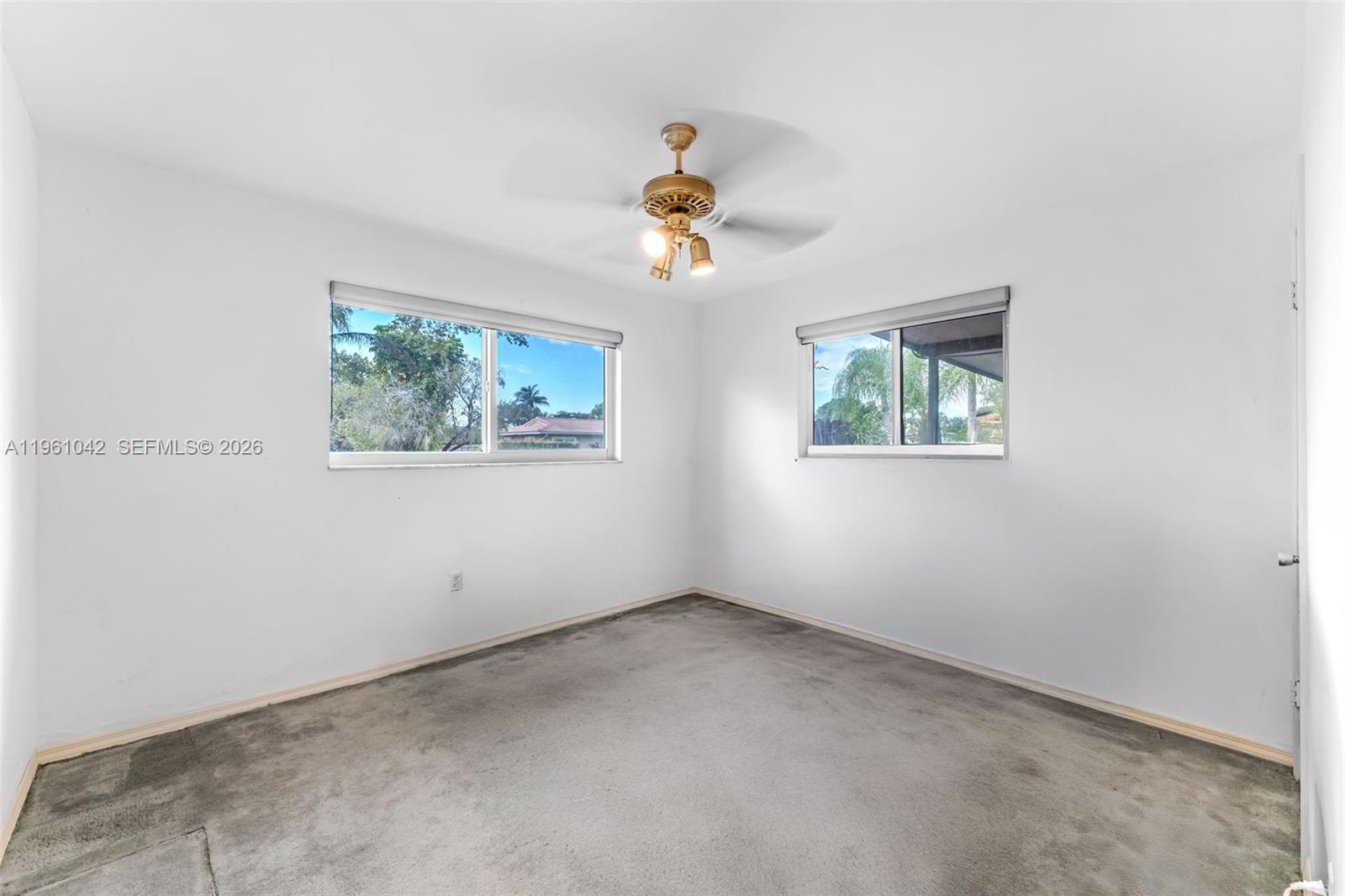 10901 Southwest 116th Street Miami, FL 33176 - Photo 17 of 26 an empty room with windows and fan
