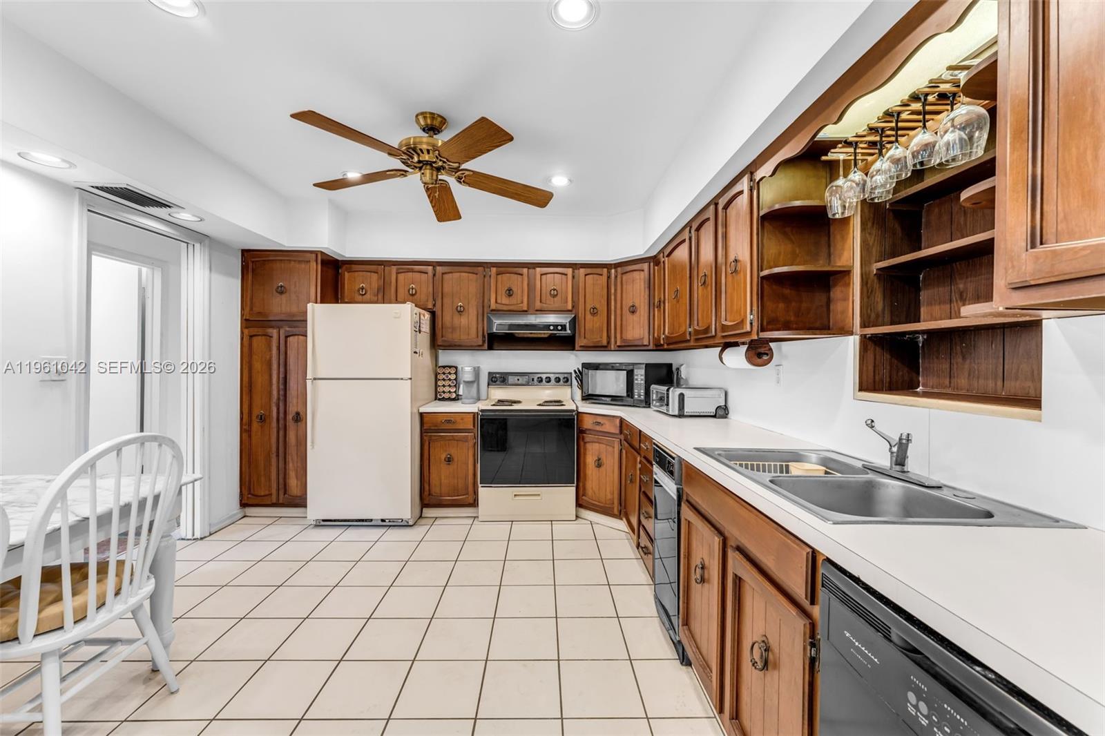 10901 Southwest 116th Street Miami, FL 33176 - Photo 9 of 26 a kitchen with a sink appliances and cabinets