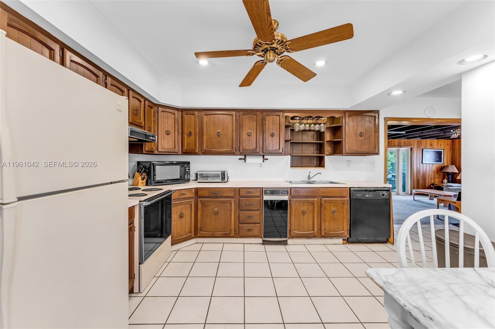 10901 Southwest 116th Street Miami, FL 33176 - Photo 10 of 26 a kitchen with stainless steel appliances granite countertop a stove top oven a sink a counter top space and cabinets