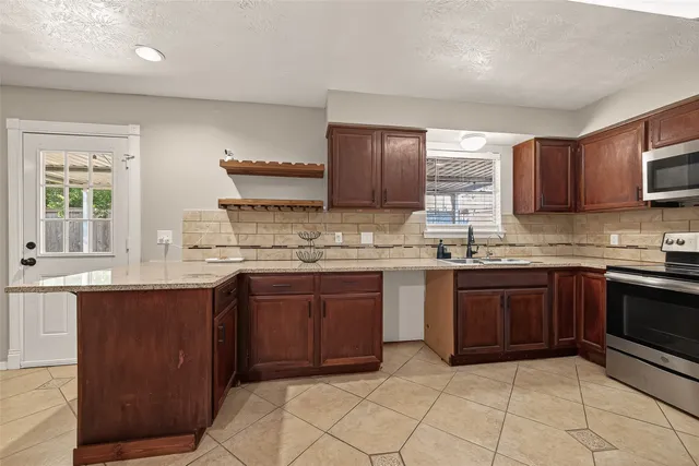 a kitchen with a sink cabinets and wooden floor