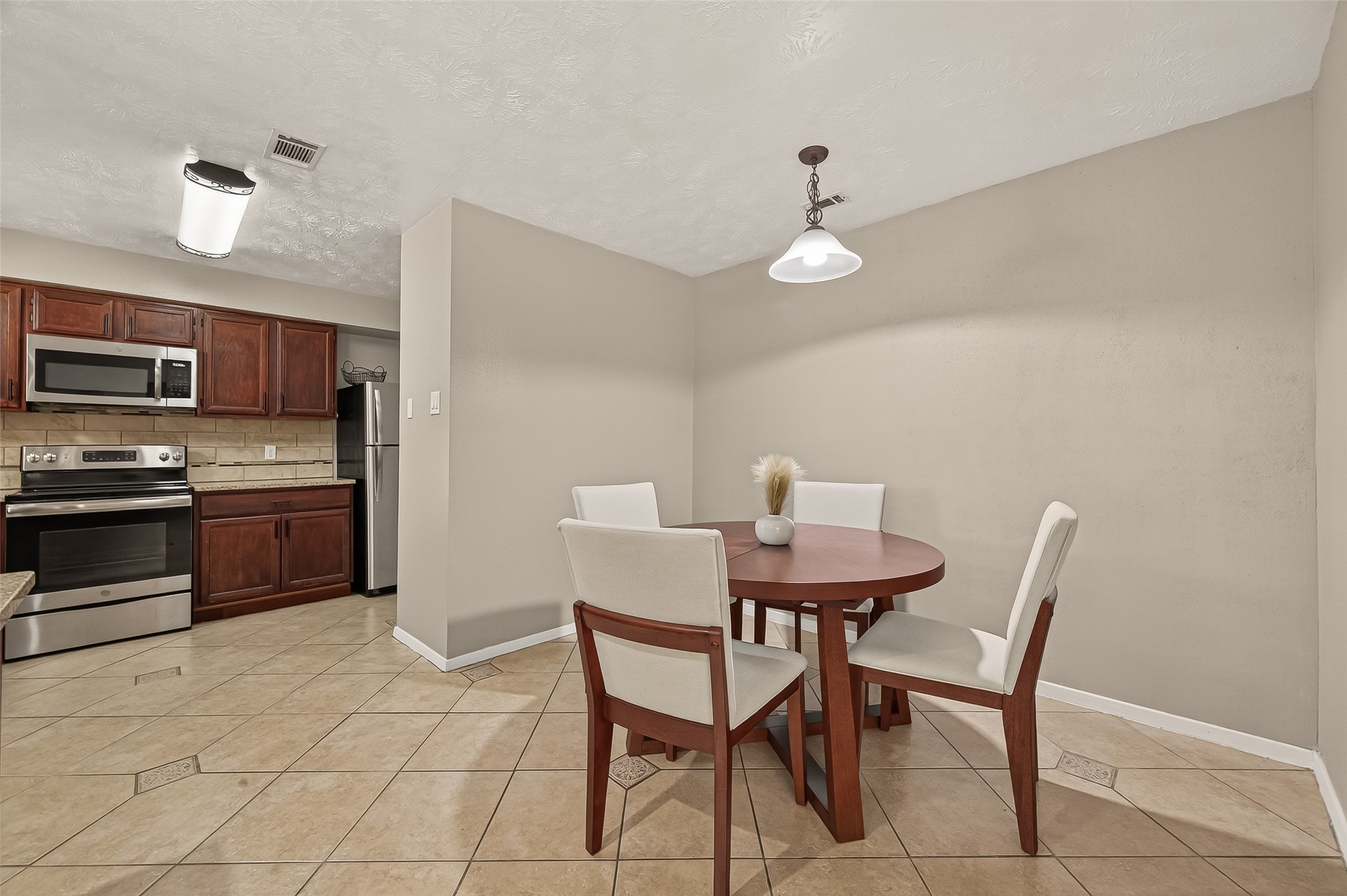1407 Somercotes Lane Channelview, TX 77530 - Photo 13 of 28 a view of a dining room with furniture and wooden floor