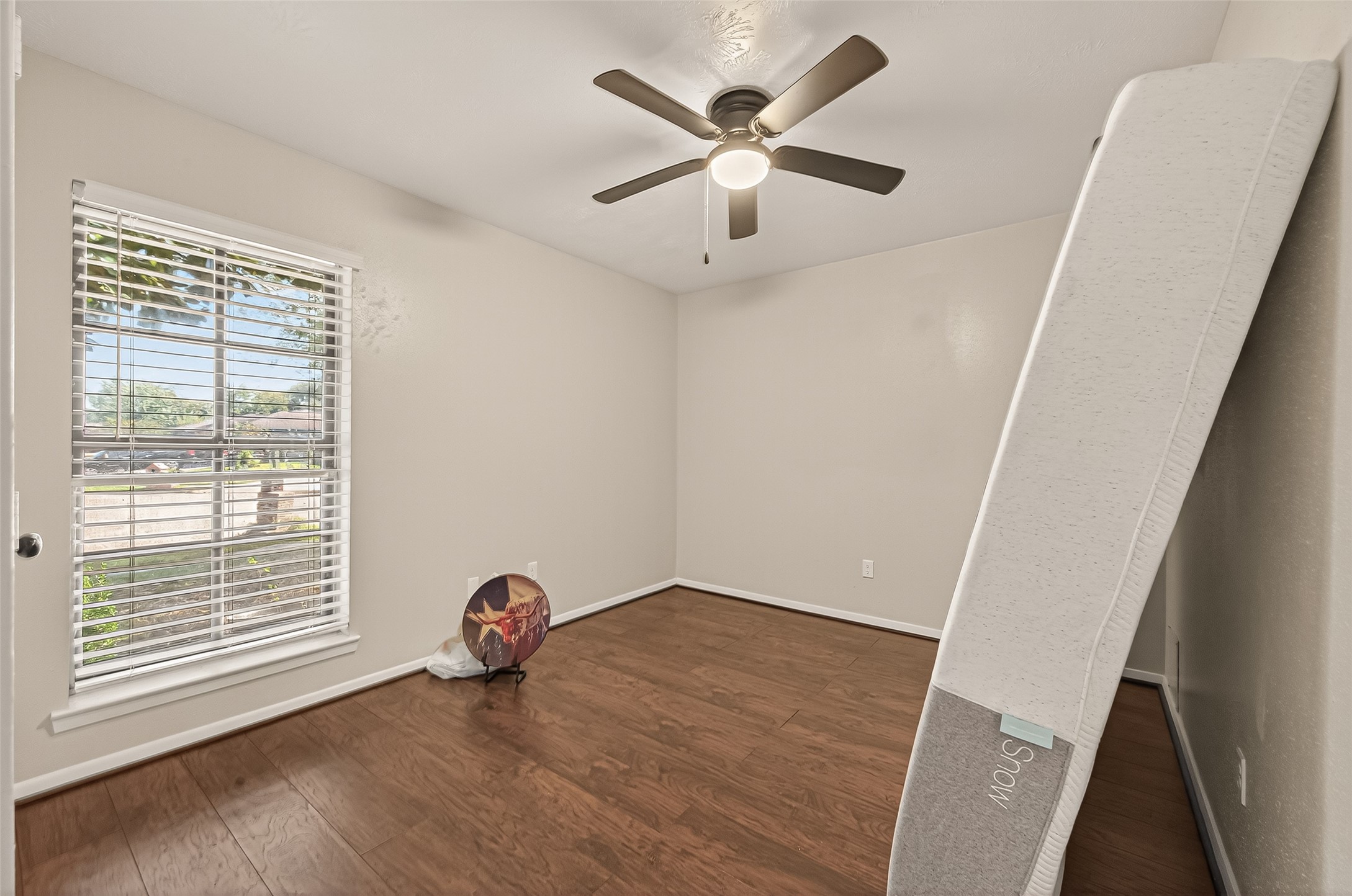 1407 Somercotes Lane Channelview, TX 77530 - Photo 21 of 28 a view of a livingroom with wooden floor and a ceiling fan
