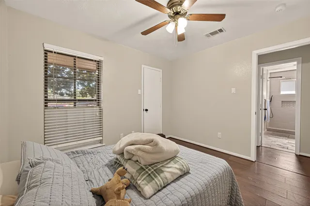 a backyard of a house with wooden fence and large trees