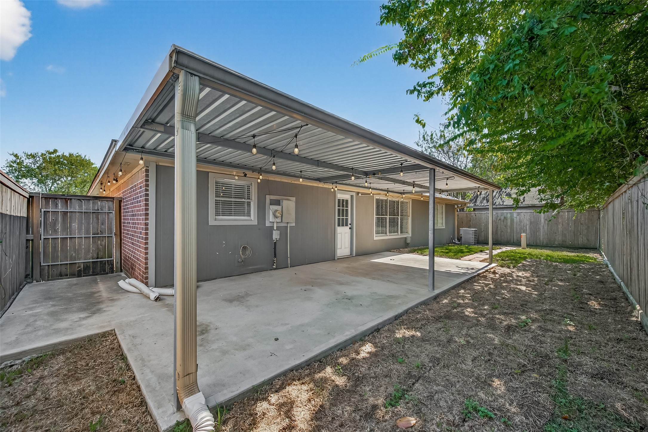 1407 Somercotes Lane Channelview, TX 77530 - Photo 24 of 28 a backyard of a house with wooden fence and large trees