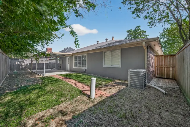 a view of a backyard with wooden fence