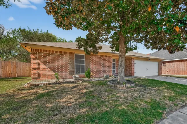 a view of a house with a yard and tree