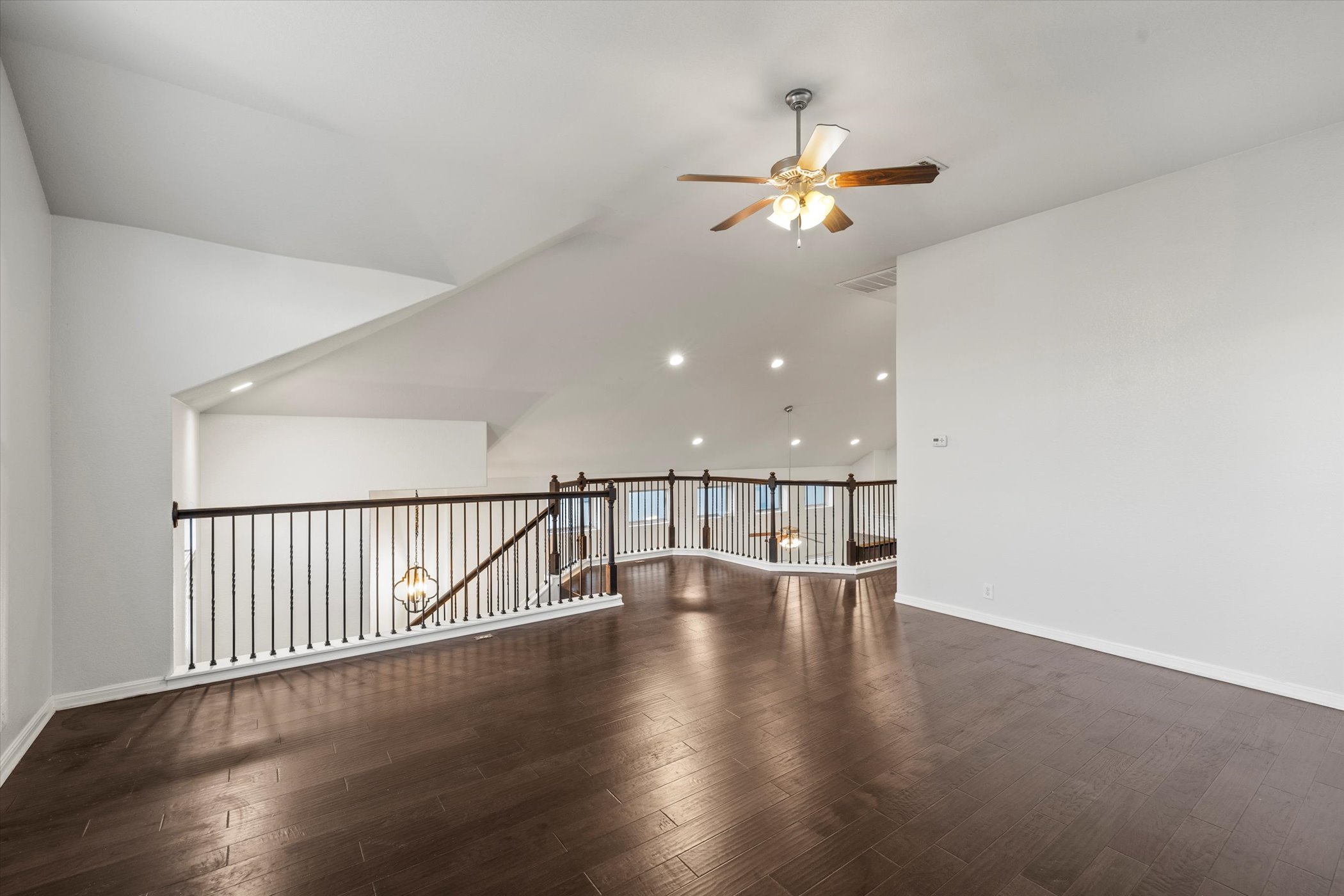 7337 Menchaca Road, Unit #22 Austin, TX 78745 - Photo 16 of 25 A different view of the media room with vaulted ceiling, wood flooring, ceiling fan, and recessed lighting