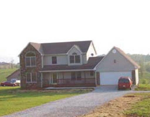 2100 Goodview Road Goodview, VA 24095 - Photo 1 of 1 a front view of a house with a yard and garage