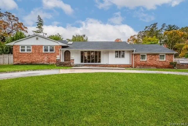 a front view of house with yard and green space