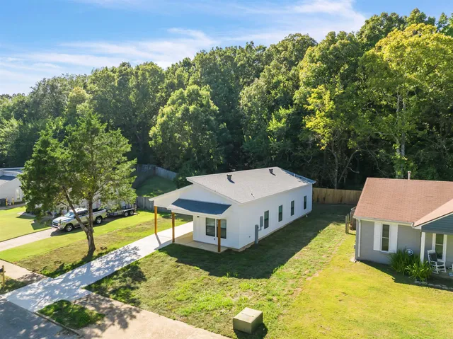 an aerial view of a house with a yard