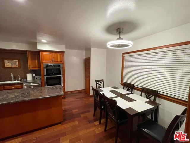 a kitchen with a sink cabinets and dining table