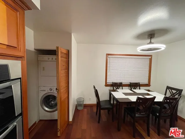a view of a a dining room with furniture window and wooden floor