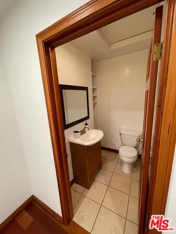 a bathroom with a sink mirror vanity and toilet