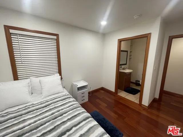 a bedroom with a bed and a mirror