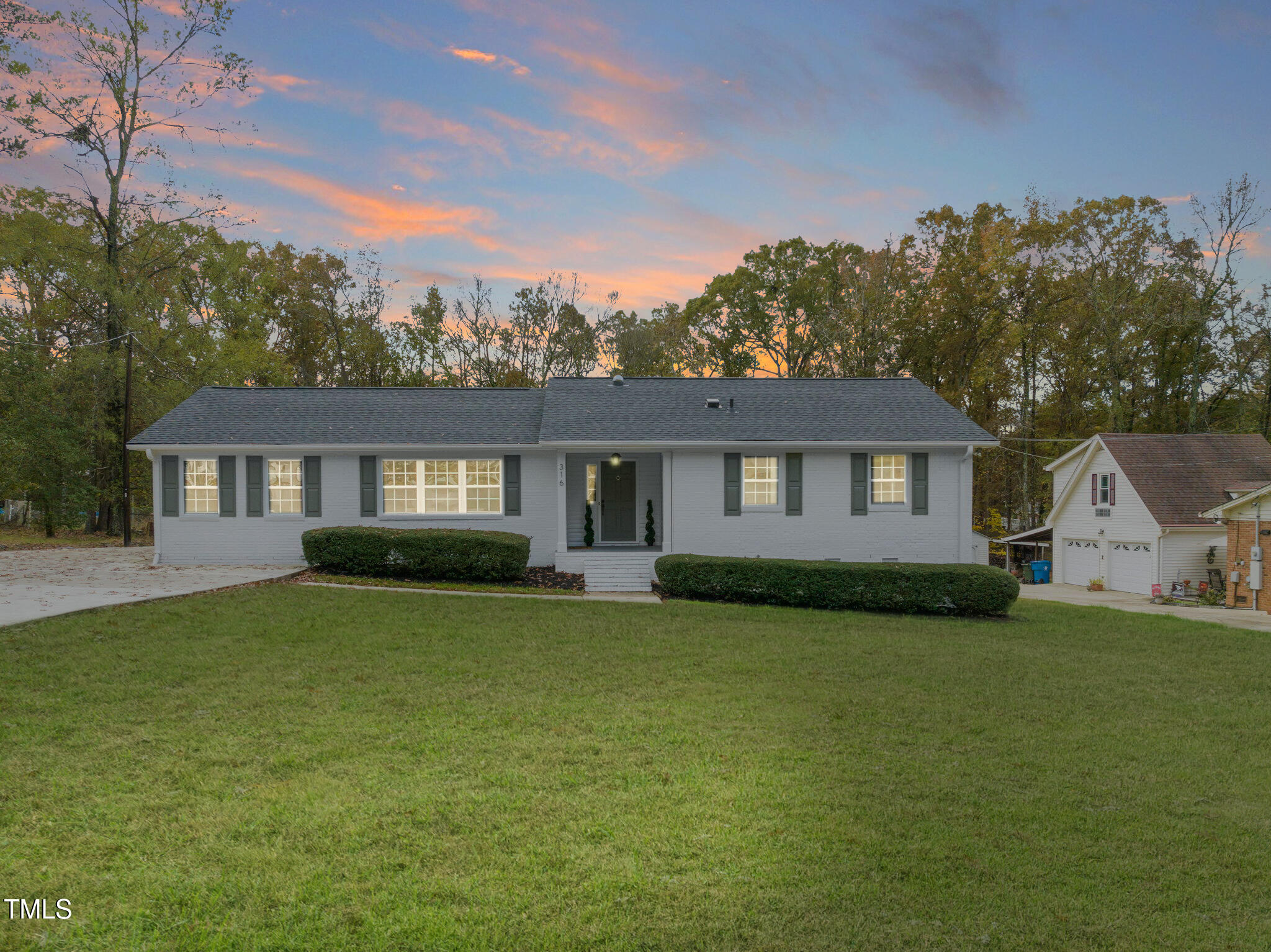 316 Ebon Road Durham, NC 27713 - Photo 48 of 48 a front view of a house with a garden and trees