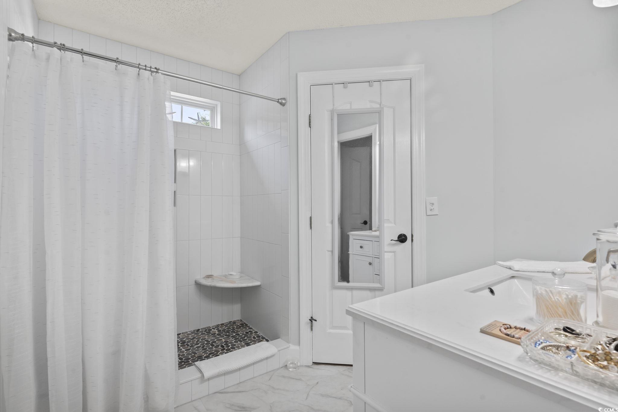 3607 Brampton Drive Myrtle Beach, SC 29588 - Photo 15 of 34 Bathroom featuring vanity, a stall shower, light marble finish flooring, and a textured ceiling