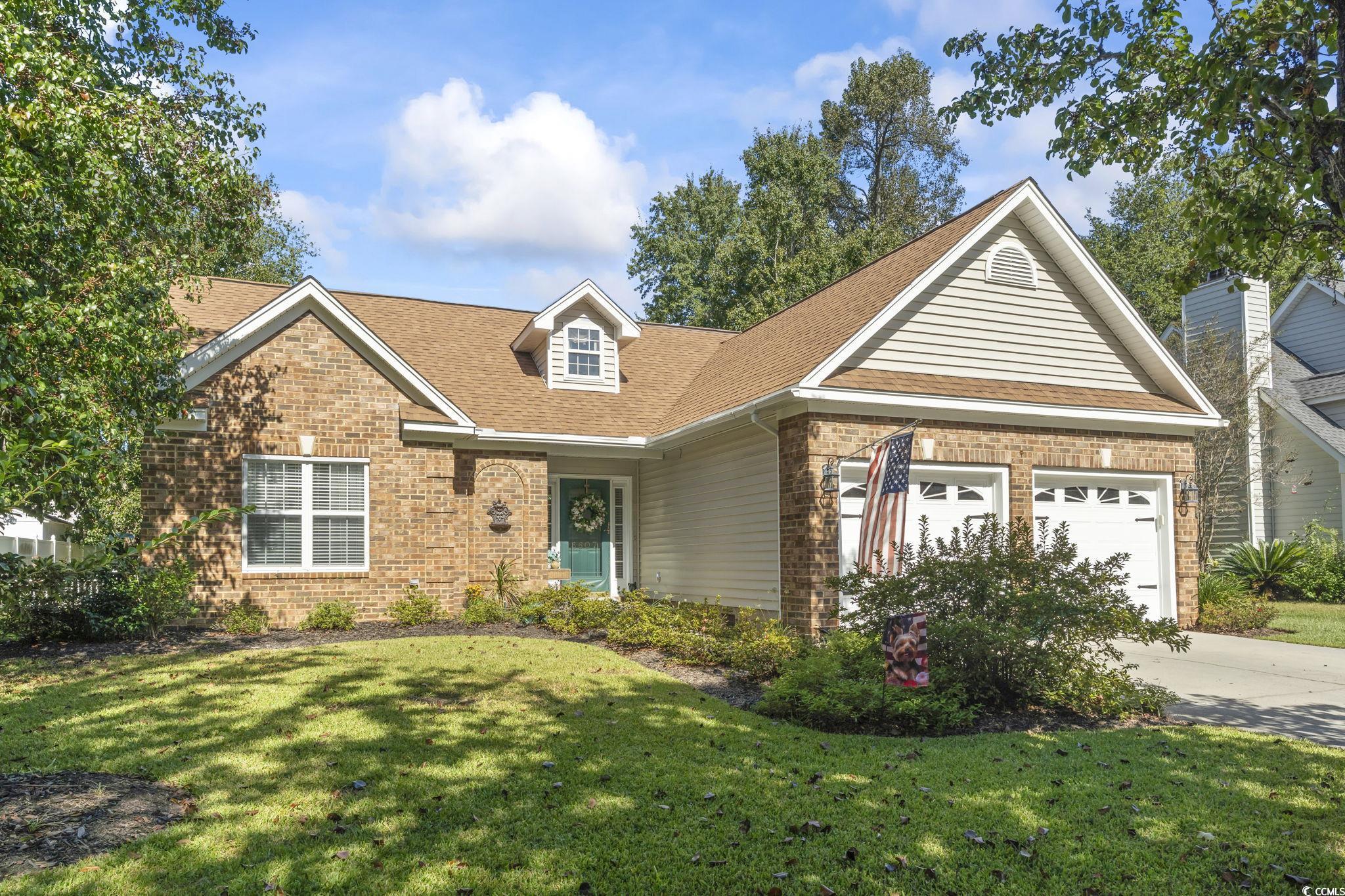 3607 Brampton Drive Myrtle Beach, SC 29588 - Photo 27 of 34 Traditional-style house with brick siding, a front lawn, an attached garage, and roof with shingles