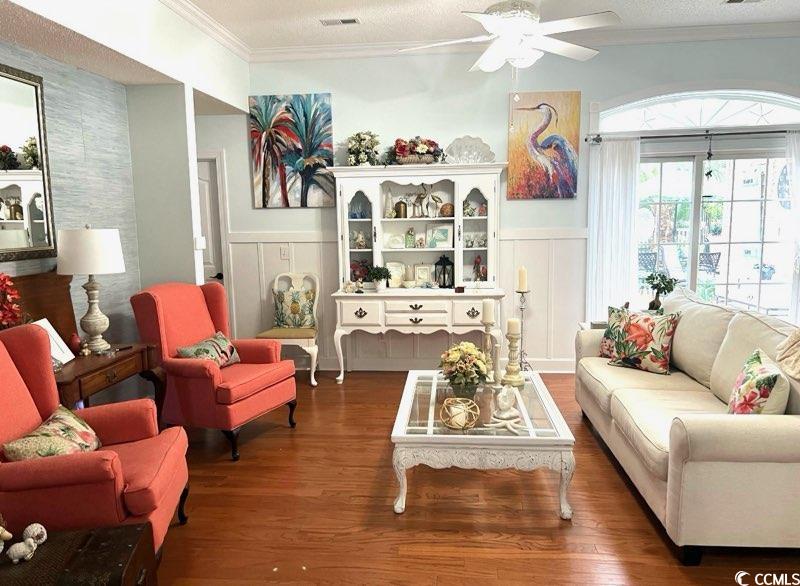 3607 Brampton Drive Myrtle Beach, SC 29588 - Photo 9 of 34 Living room featuring ornamental molding, wood finished floors, a wainscoted wall, a ceiling fan, and a decorative wall
