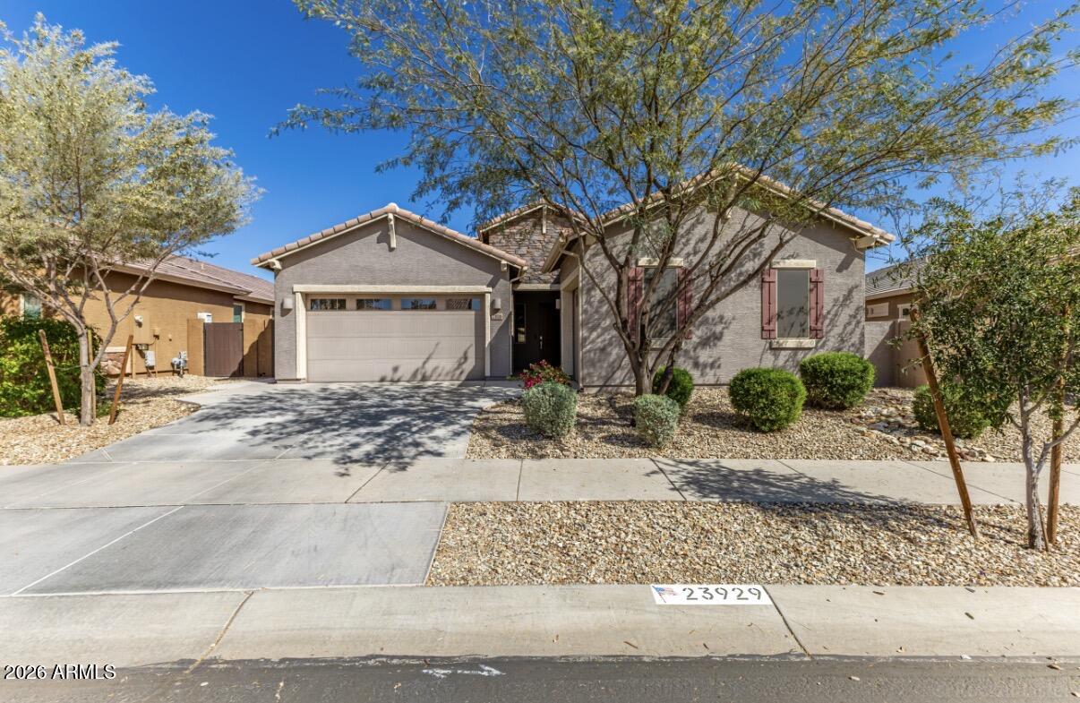 23929 North 166th Lane Surprise, AZ 85387 - Photo 1 of 23 a front view of a house with a yard