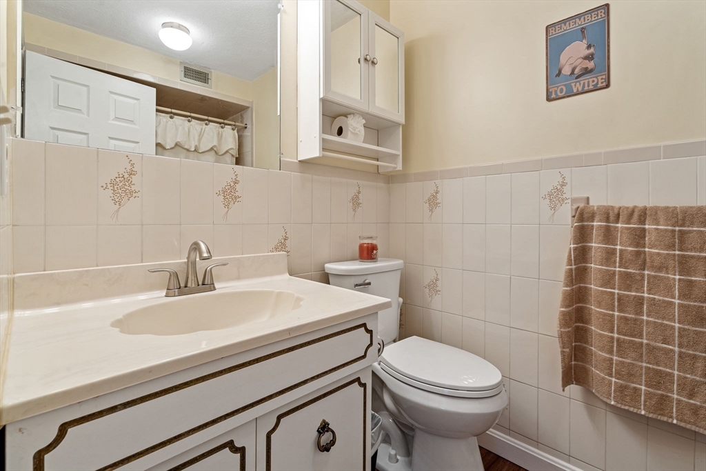135 Forest Street, Unit W2 Saugus, MA 01906 - Photo 15 of 23 a bathroom with a sink a toilet and a mirror