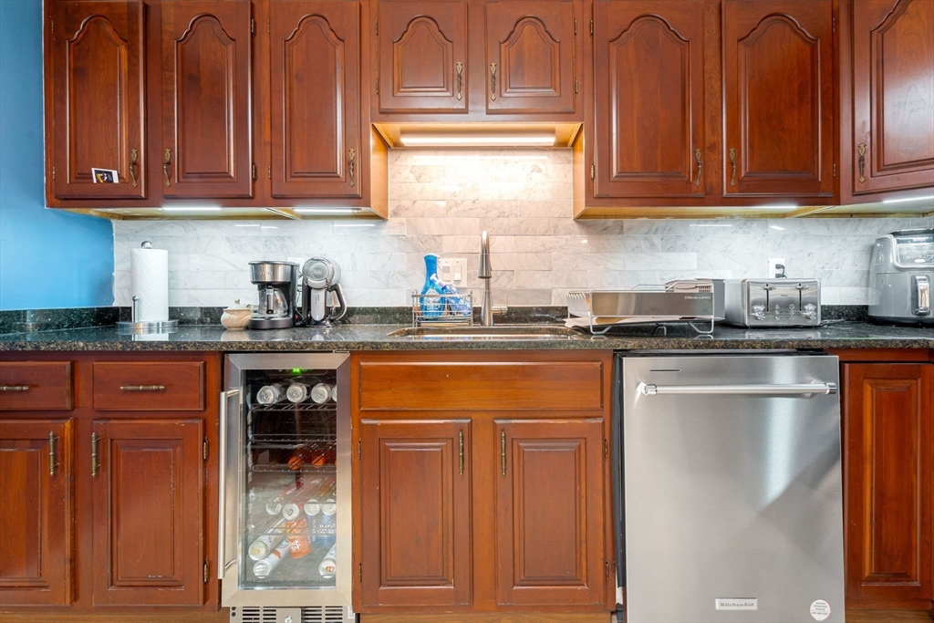 135 Forest Street, Unit W2 Saugus, MA 01906 - Photo 2 of 23 a kitchen with stainless steel appliances granite countertop a refrigerator and cabinets