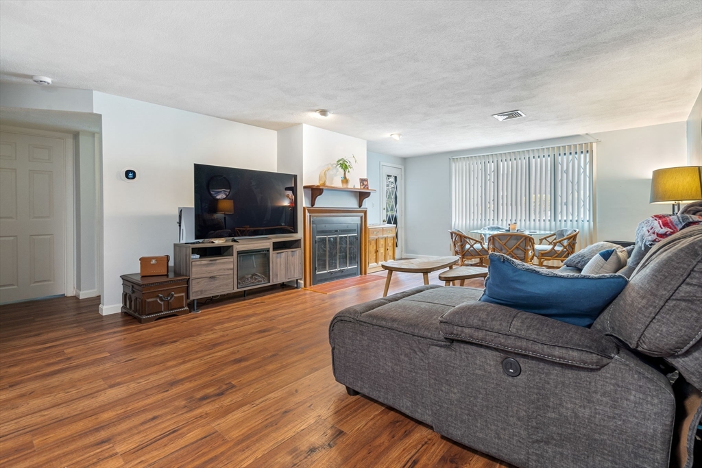 135 Forest Street, Unit W2 Saugus, MA 01906 - Photo 4 of 23 a living room with furniture and a flat screen tv