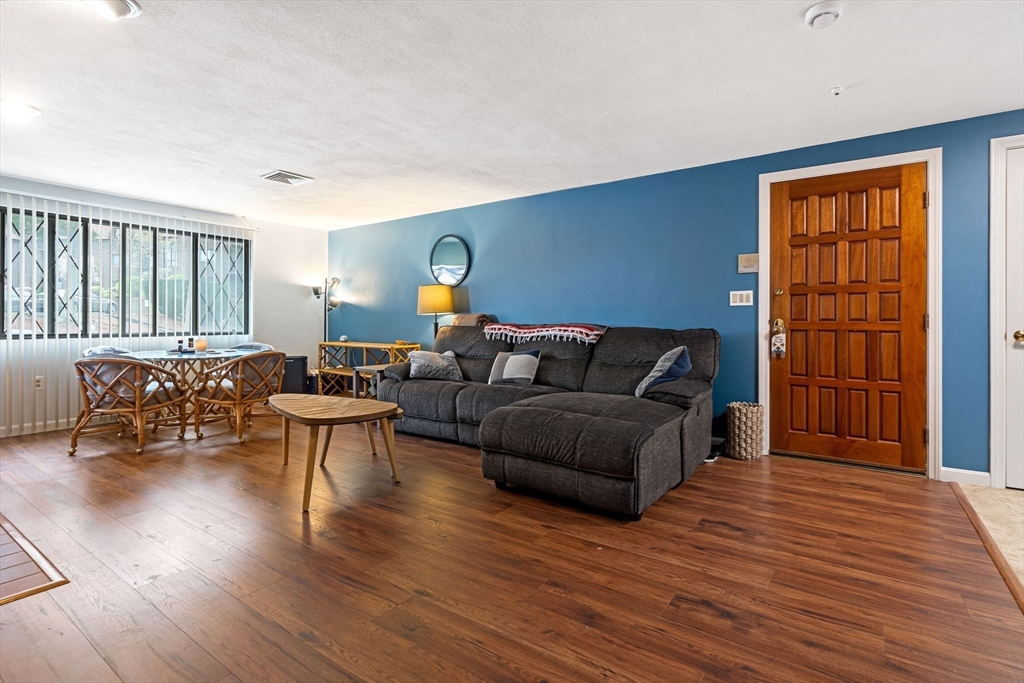 135 Forest Street, Unit W2 Saugus, MA 01906 - Photo 7 of 23 a living room with furniture and a wooden floor