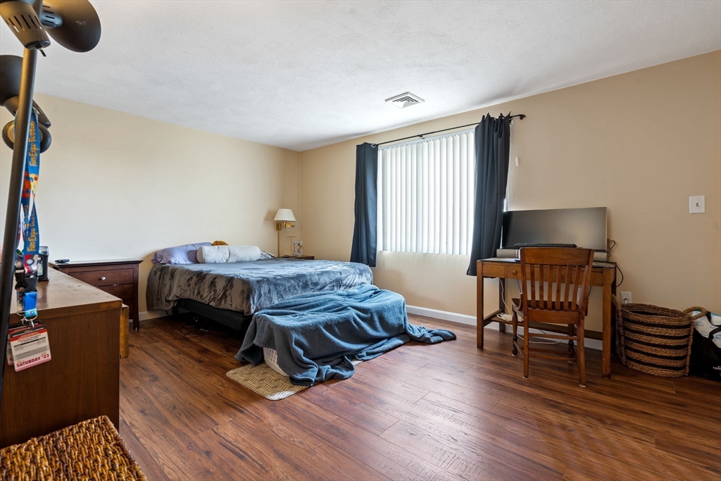 135 Forest Street, Unit W2 Saugus, MA 01906 - Photo 9 of 23 a bedroom with furniture and a wooden floor