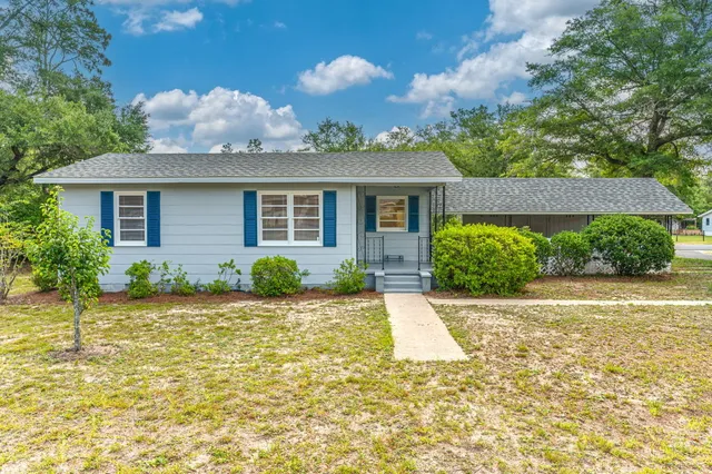 a front view of a house with garden