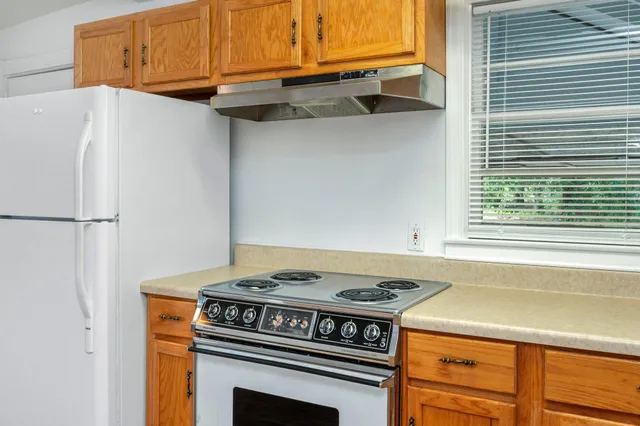 a kitchen with a stove and a refrigerator