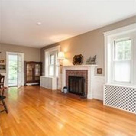 58 Governors Road Milton, MA 02186 - Photo 7 of 30 a view of a livingroom with a fireplace and a window
